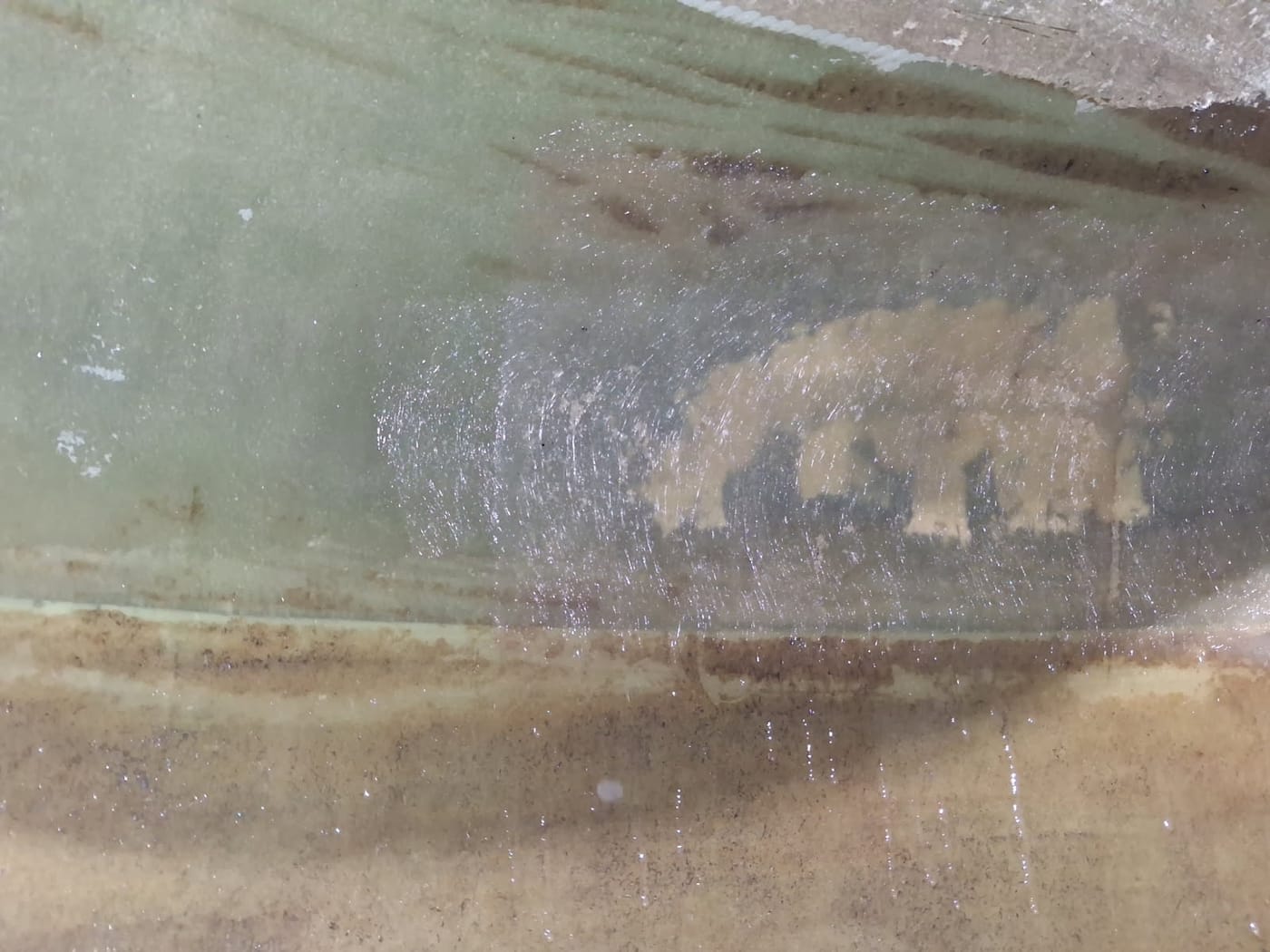 Fibreglass reinforcement laminated over the crack in the internal wall of a water tank, after repair, Brisbane