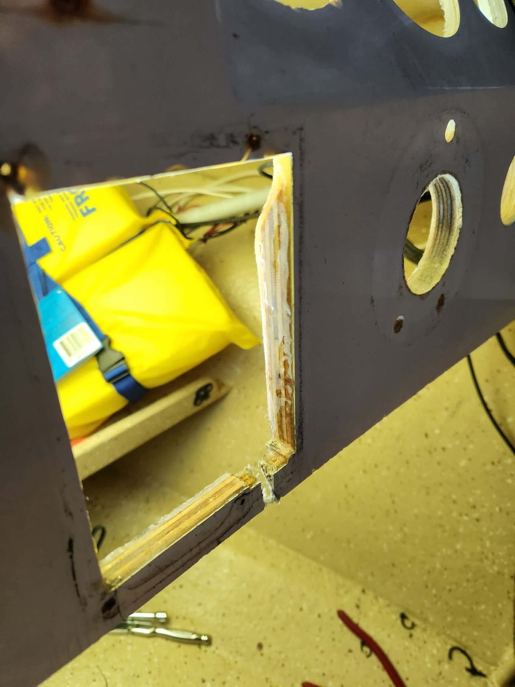 Boat console with a rectangular cut-out exposing the timber core before fibreglass repair, Brisbane