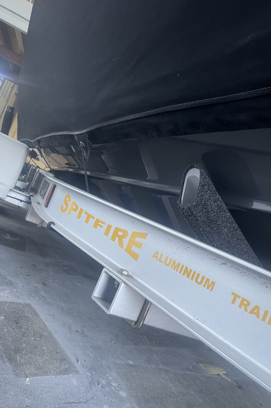 Boat hull side restored to a deep gloss black finish after gelcoat repair, Brisbane