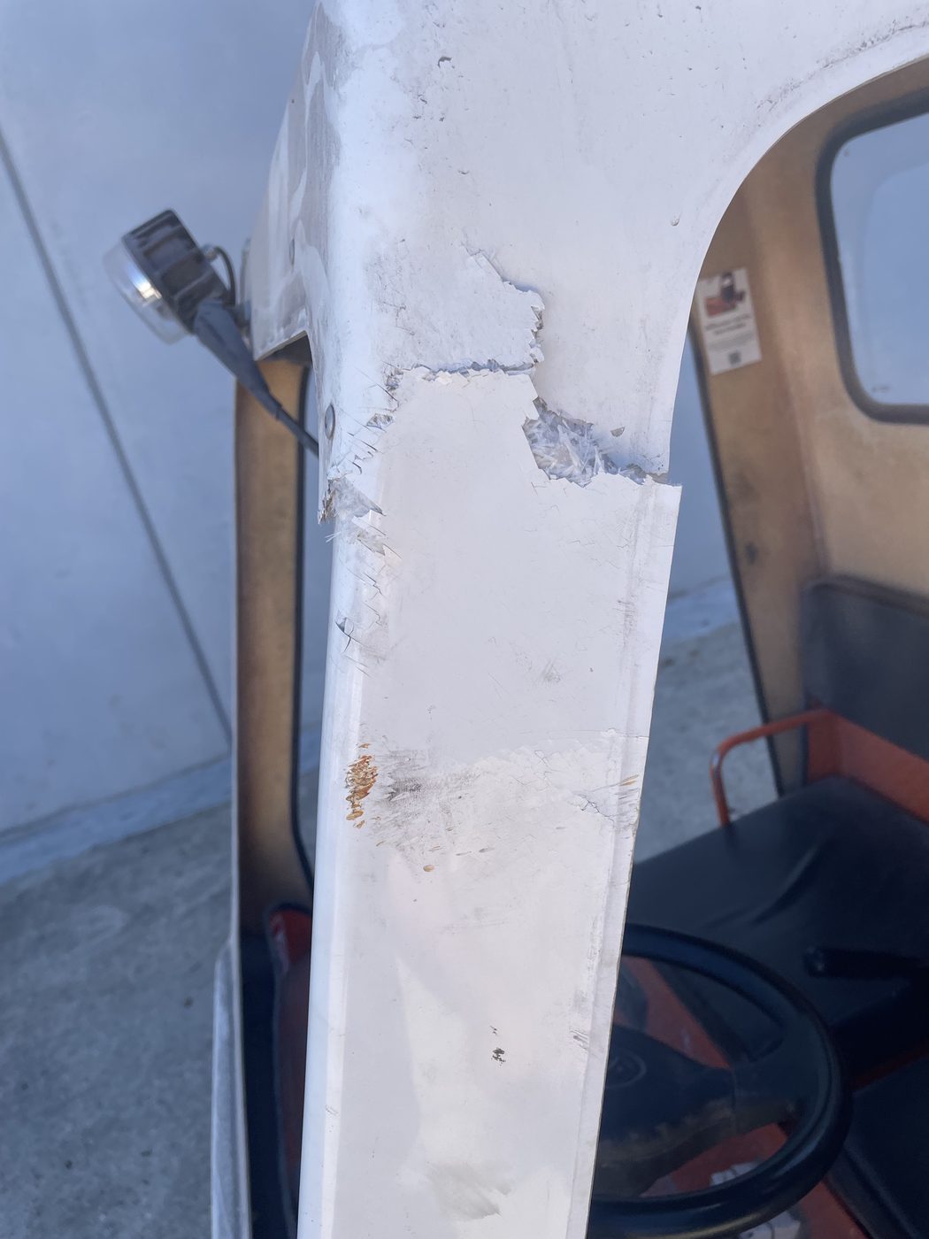 Cracked fibreglass windscreen pillar on a machine cab before repair, Brisbane