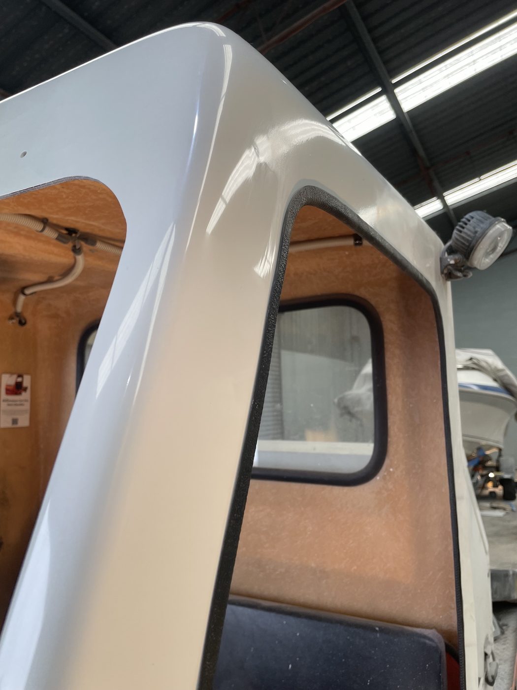 Machine cab windscreen pillar repaired and finished in gloss white, Brisbane
