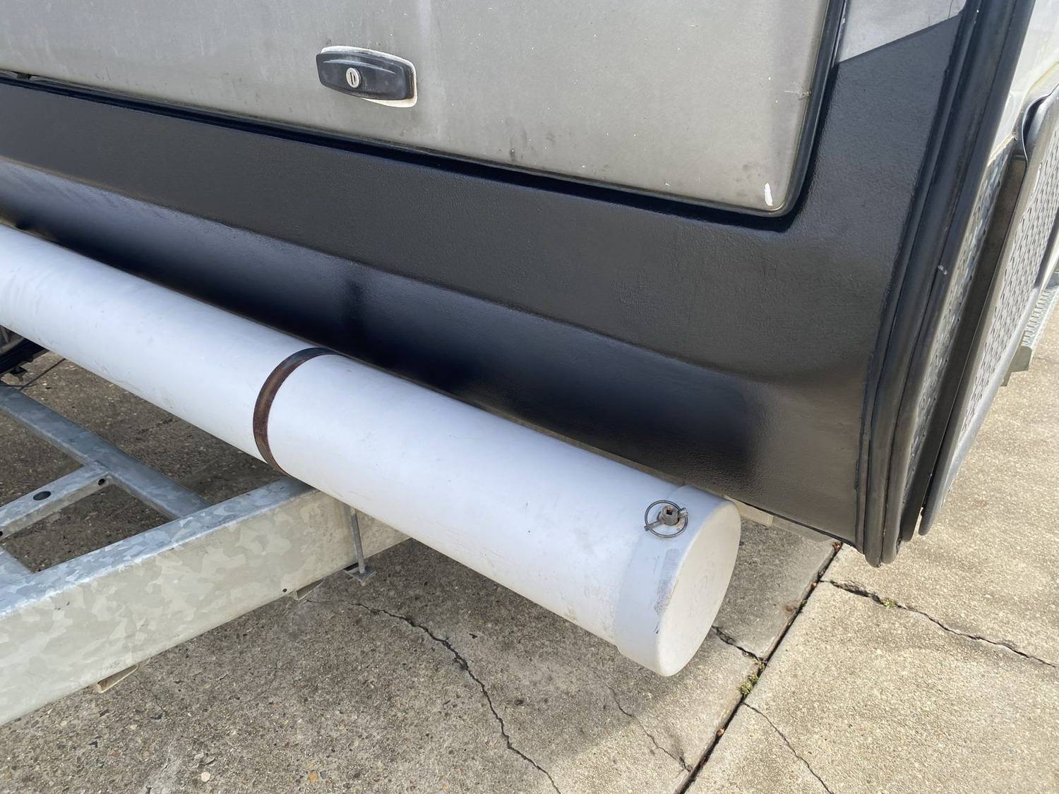 Caravan front lower panel repaired with smooth black finish, Brisbane