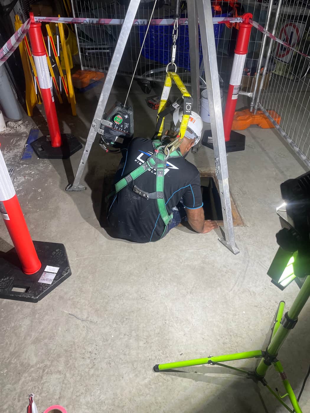 Confined space entry to a water tank with tripod, winch and full body harness, Brisbane