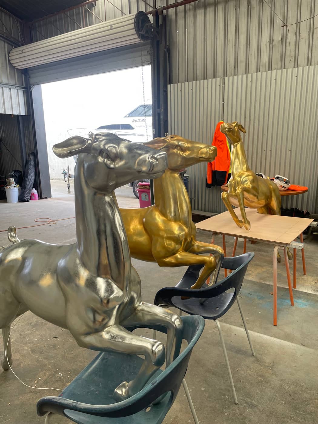 Fibreglass leaping deer sculptures finished in metallic gold and silver in the LBM Fibreglass workshop, Brisbane