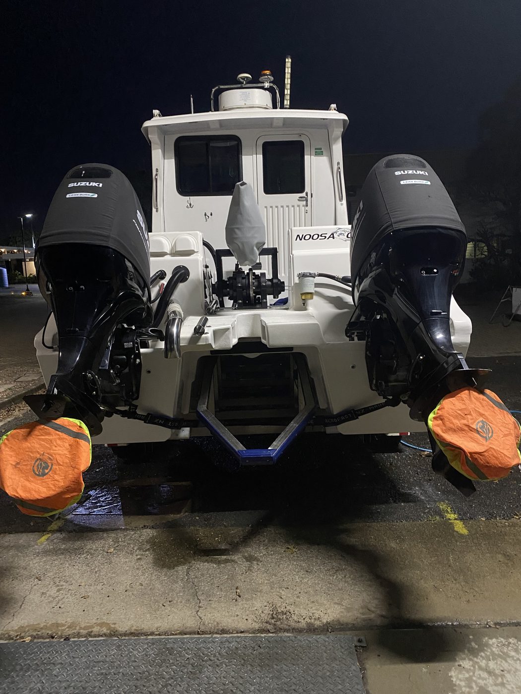 Patrol boat stern with twin Suzuki outboards after detailing, Brisbane