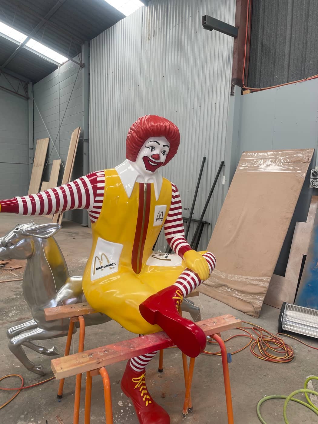 Large seated fibreglass character statue repaired and refinished in the workshop, Brisbane
