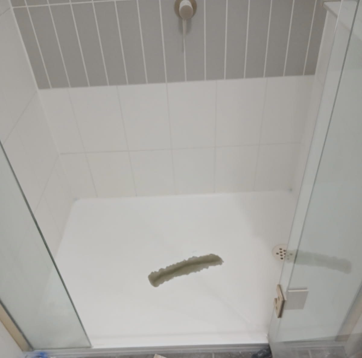 Damaged fibreglass shower base before repair, Brisbane
