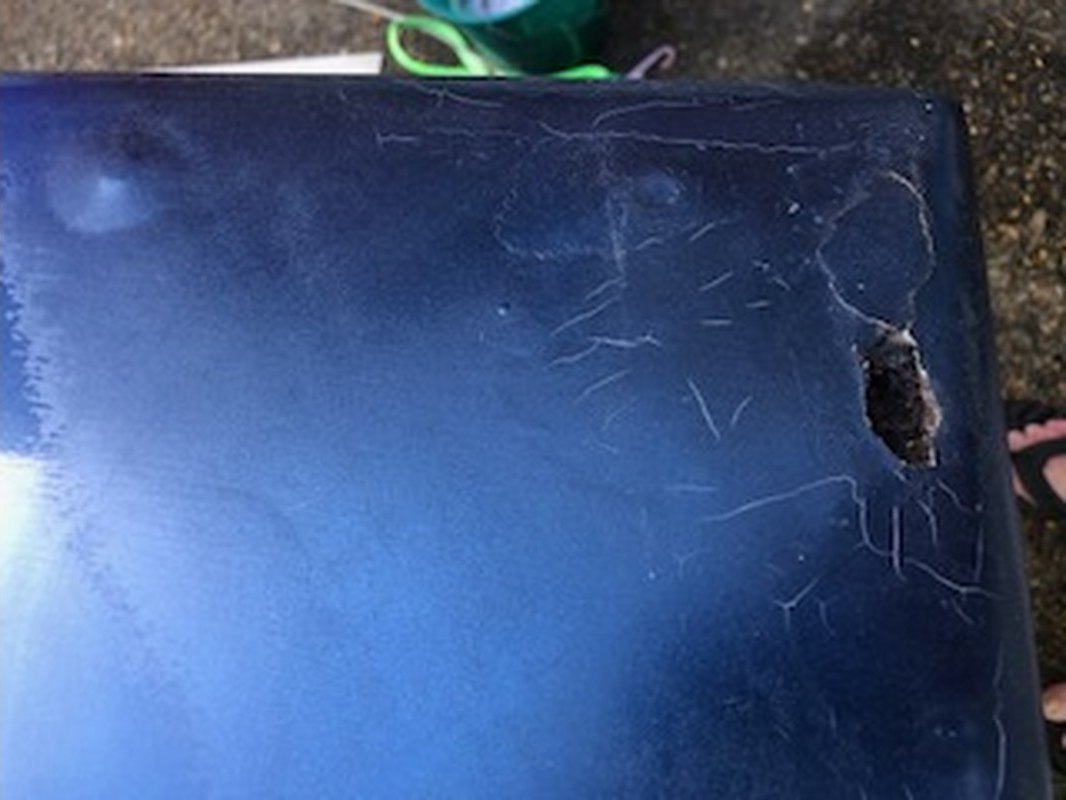 Spider cracking and a hole through the deck corner of a clinker ski boat before fibreglass repair, Brisbane