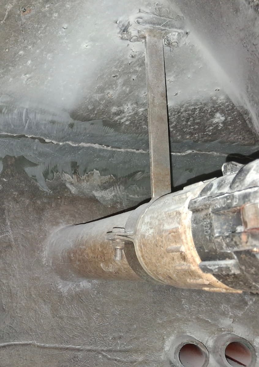 Crack in the internal wall of a water tank at the pipe penetration and steel stay before repair, Brisbane