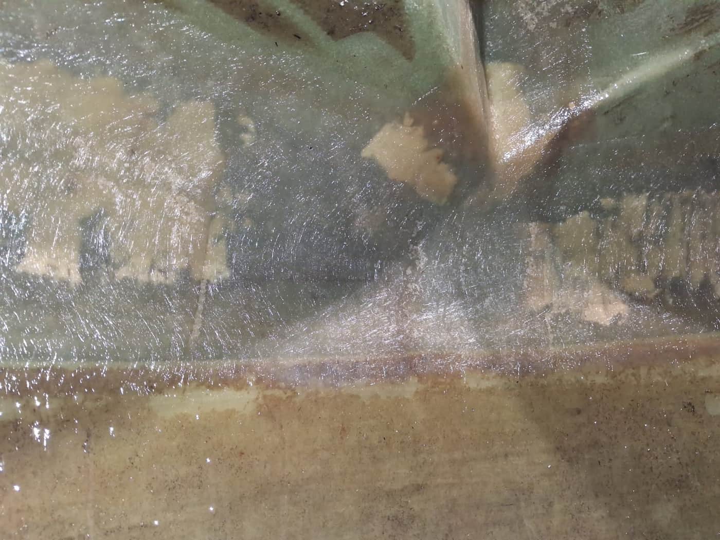 Internal wall of a fibreglass water tank with the crack repaired and sealed, Brisbane